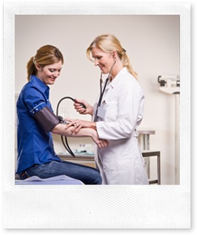 Doctor checking woman blood pressure