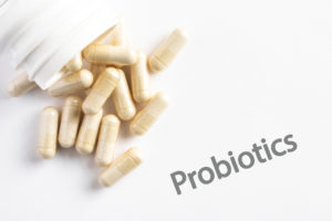 Probiotic Capsules Spilled from a Bottle on white background