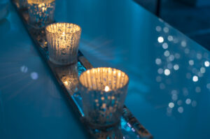 Sparkling candles on a table with blue light background