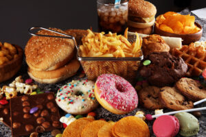 picture of collection of ultraprocessed foods, doughnuts, fries, sugary drinks, etc. 